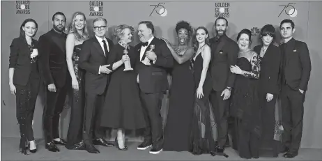  ?? JORDAN STRAUSS, INVISION/AP ?? The cast and crew of “The Handmaid’s Tale” pose Sunday in the press room with the award for Best Television Series - Drama at the 75th annual Golden Globe Awards at the Beverly Hilton Hotel in Beverly Hills, Calif.