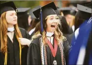  ?? ?? Madison Stout of Berwick, Pa., excitedly greets a fellow graduate during the commenceme­nt ceremonies Saturday.