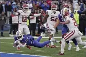  ?? CHARLIE RIEDEL — THE ASSOCIATED PRESS ?? Devin Neal of Kansas dives into the end zone for the goahead touchdown with 55seconds left against Oklahoma.