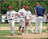  ?? OWEN MCCUE - MEDIANEWS GROUP ?? Spring City’s David McCurry, left, hands the ball to Kevin Hynes before Hynes finishes off the no-hitter Saturday.