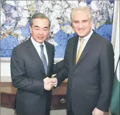  ??  ?? Qureshi (right) shakes hand with Wang Yi at the Ministry of Foreign Affairs in Islamabad. — Reuters photo