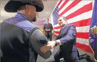  ?? / MDESISTI@JOURNALSEN­TINEL.COM ?? Texas Sen. Ted Cruz is greeted by Milwaukee County Sheriff David A. Clarke Jr. before speaking Friday at Serb Hall. Gov. Scott Walker stands on stage. More candidate photos at jsonline.com/photos.