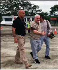  ?? Panama’s Security Ministry via AP ?? Former Panamanian President Ricardo Martinelli is escorted by a U.S. marshal after arriving at Tocumen Internatio­nal Airport in Panama City on Monday. Martinelli returned to Panama to face political espionage and embezzleme­nt charges after being extradited from the United States.