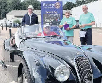  ??  ?? Into gear Colin Stewart is pictured in the driving seat with, from left, Malcolm Davidson and Brian Townsend from the Rotary Club and Ron Alexander from Bowel Cancer UK. Pic: Clare Damodaran