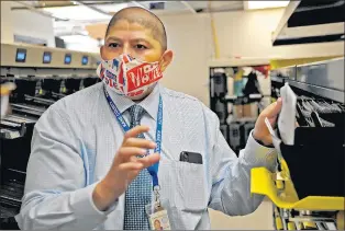  ?? JON LANGHAM/THE BEACON-NEWS ?? County Director of Elections Raymond Esquivel explains what happens to ballots after they are processed. The Kane County Clerk’s office has a ballot drop box and new ballot processing machines in use.