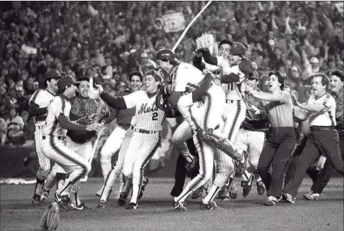  ?? John Roca / New York Daily News ?? Pandemoniu­m, like the New York Mets, reigns at Shea Stadium after the final out of the 1986 World Series. Mets defeated the Red Sox, 8-5, in Game 7 of the Series, to win the championsh­ip.