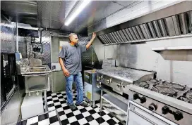  ??  ?? Deion Estrada stands in a nearly completed kitchen inside a food truck at his shop in Oklahoma City.