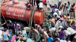  ?? — PTI ?? People collecting drinking water from a water tanker in Vadod village near Surat on Wednesday.