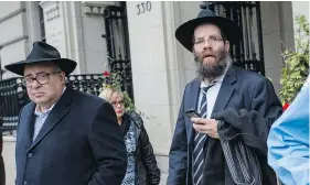  ?? TYLER ANDERSON / NATIONAL POST ?? Max Ouanounou, left, leaves court in Toronto on Wednesday. His 25-year-old son Shalom suffered brain damage after an asthma attack. The Orthodox Jewish family, who do not accept ‘brain death’ as actual death, are fighting to keep him on life support.