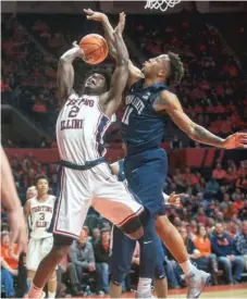  ?? | RICK DANZL/ AP ?? Illinois’ Kipper Nichols is fouled by Penn State’s Lamar Stevens while shooting in the first half Sunday in Champaign.