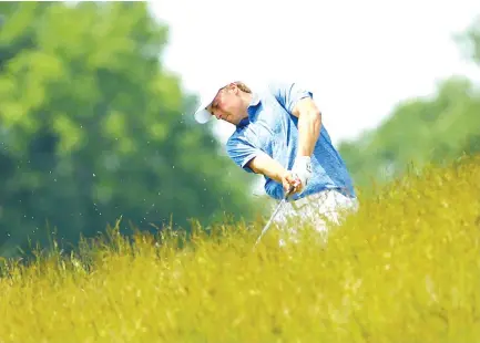  ??  ?? Jordan Spieth hits out of the tall grass off the 8th fairway during a practice round for the US Open golf tournament at Erin Hills on Monday. (USA TODAY Sports)