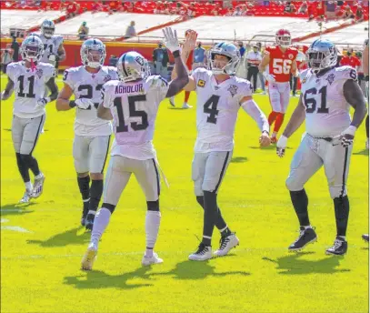  ?? Heidi Fang Las Vegas Review-journal @Heidi Fang ?? Nelson Agholor and Derek Carr celebrate Agholor’s touchdown reception in the Raiders’ 40-32 win against the Chiefs on Oct. 11.