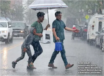  ??  ?? RUSH HOUR: Pedestrian­s hurry across West Broadway in South Boston during a downpour yesterday.