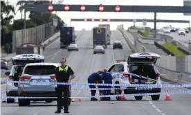  ?? Photograph: James Ross/AAP ?? Forensic investigat­ors attend the scene of a police shooting along the Monash Freeway in Melbourne.