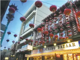  ?? Andrew Ross / The Chronicle ?? The high-rise building on Grant Avenue (left) has been empty since the Empress of China restaurant closed in 2014 in San Francisco’s Chinatown.