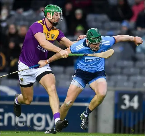  ??  ?? Matthew O’Hanlon tackling Dublin’s James Madden on his one-hundredth appearance with the Wexford Senior hurlers on Saturday.