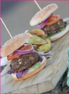  ??  ?? Indulge in a homemade burger with potato wedges.