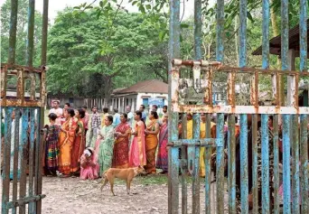  ?? AFP ?? Amid turbulence: People stand in a queue to cast their votes at a polling station in Kalamati village, Dinhata district of West Bengal on Friday.