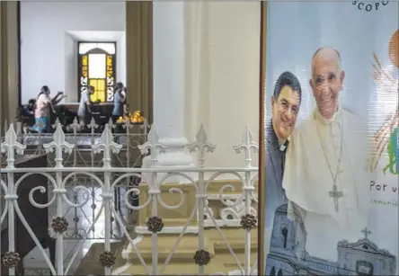  ?? Inti Ocón Associated Press ?? BISHOP Rolando Álvarez was sentenced on charges of underminin­g the government, spreading false informatio­n, obstructio­n of functions and disobedien­ce. Above, a poster featuring Álvarez and Pope Francis hangs inside the cathedral in Matagalpa, Nicaragua, in August.