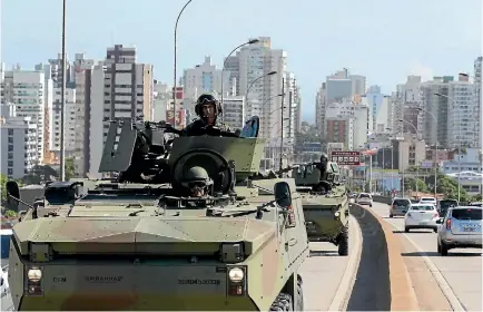  ?? PHOTO: REUTERS ?? Brazilian Marines patrol a street in Vitoria, Espirito Santo.