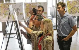  ??  ?? Austin District 3 City Council Member Sabino “Pio” Renteria (center) goes over his district maps with others during a CodeNext open house in September at City Hall. Austin citizens should talk to council members and encourage them to develop the best...