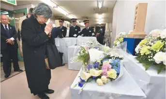  ??  ?? Shizue Takahashi rend hommage à son époux, un employé du métro de Tokyo tué lors de l’attaque au gaz sarin de 1995. - Associated Press