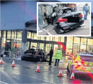  ??  ?? ●●The BMW after ploughing into the Aldi store on Mellor Street, on Monday evening