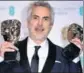  ?? AP ?? Alfonso Cuaron with Best Film and Best Director awards.