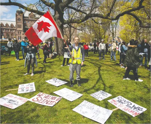  ?? Chri
s You
ng / THE CANADIAN PRESS ?? Protesters gather outside the Ontario Legislatur­e in Toronto in May to demonstrat­e against numerous issues relat
ing to the pandemic. Researcher­s say conspiracy theories around COVID-19 are spreading at an alarming rate.