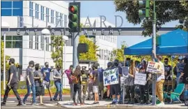  ?? Allen J. Schaben Los Angeles Times ?? WORKERS WANT CEO Bobby Kotick, who reportedly knew of sexual misconduct claims but kept them from the board, to step down. Above, a walkout in July.