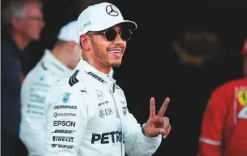 ?? Reuters ?? Mercedes driver Lewis Hamilton celebrates after taking pole at the Azerbaijan Grand Prix yesterday. He claimed the 66th pole of his career, pulling clear of Ayrton Senna’s mark.