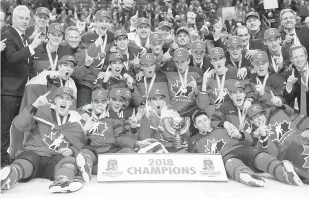  ??  ?? Team Canada poses for the winner’s photo after beating Sweden in the gold-medal game in Buffalo on Friday.
