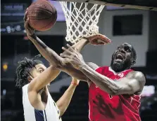  ?? DAX MELMER ?? Windsor’s Juan Pattillo, right, attempts a layup against Saint John’s TJ Maston in NBLC action at the WFCU Centre on Friday.