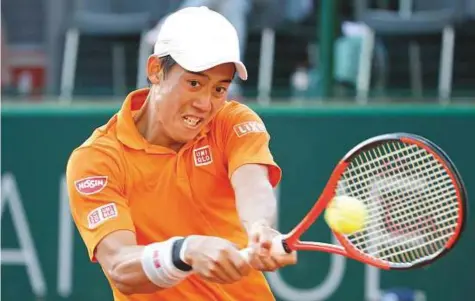  ?? AP ?? Kei Nishikori returns the ball to Mikhail Kukushkin of Kazakhstan during their second round match at the Geneva Open on Tuesday. Nishikori hopes a deep run in the Swiss competitio­n can spark a revival in his fortunes.