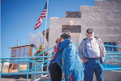  ?? ROBERTO E. ROSALES/JOURNAL ?? Pie Town residents Jean Moss, left, and Nita Larronde embrace outside the town’s post office as Ken Bostick, who retired in Pie Town 15 years ago, stands by. The Postal Service announced recently it is closing the post office because the building is...