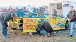  ??  ?? Niagara Falls driver Sam Pennacchio's crew prepares the Late Model racer for the feature Sunday night.