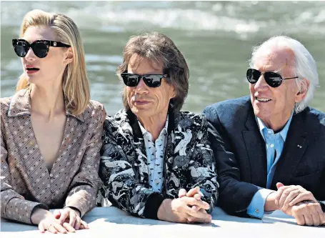  ??  ?? Elizabeth Debicki, Mick Jagger and Donald Sutherland, who star in the film The Burnt Orange Heresy, arrived by boat at the Palazzo del Casino for its screening at the 76th Venice Film Festival. In the thriller, the Rolling Stones frontman plays an art dealer who stages an interview with an artist in an attempt to steal a valuable painting from him.