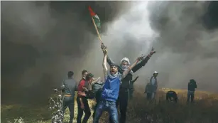  ?? (Reuters) ?? PALESTINIA­N DEMONSTRAT­ORS demand the right to return to their homeland, at the Israel-Gaza border east of Gaza City in April 2018.