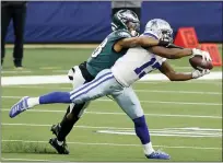  ?? MICHAEL AINSWORTH - THE ASSOCIATED PRESS ?? Dallas Cowboys wide receiver Michael Gallup (13) catches a pass as Philadelph­ia Eagles cornerback Michael Jacquet (38) defends in the first half of an NFL game in Arlington, Texas, Sunday.