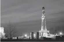  ?? [THE OKLAHOMAN ARCHIVES] ?? A rig drills a well owned in part by Panhandle Oil and Gas Inc. in 2017.