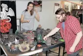  ?? PICTURE: SIBUSISO NDLOVU ?? TABLE-TOP TABLEAU: Gamers Cate Bredenkamp and Kevin Oels fight it out in a tabletop miniatures battle game at Shelley Kirby’s shop in Westville.