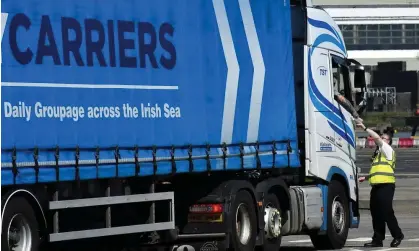  ?? Photograph: Clodagh Kilcoyne/Reuters ?? A port worker checks the paperwork of a Scotland-bound truck in Larne, Northern Ireland.