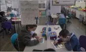  ?? JAE C. HONG — THE ASSOCIATED PRESS ?? Pre-kindergart­en students work on their school work at West Orange Elementary School in Orange.