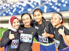  ??  ?? GOLDEN QUARTET: (L-R) Easter Joanne, Chelsea, Puteri and Feova Lim are all smiles after winning gold for Sabah in the 4x100m relay.