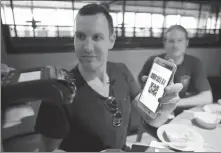  ?? PROVIDED TO CHINA DAILY ?? A foreign resident uses a mobile payment app at a restaurant in Hangzhou, Zhejiang province.