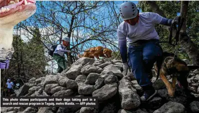 ?? ?? This photo shows participan­ts and their dogs taking part in a search and rescue program in Taguig, metro Manila. — AFP photos