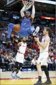  ?? WILFREDO LEE - THE ASSOCIATED PRESS ?? Oklahoma City Thunder forward Carmelo Anthony (7) dunks the ball against Miami Heat guards Goran Dragic (7) and Wayne Ellington (2) during the first half of an NBA basketball game, Monday, April 9, 2018, in Miami. The Thunder defeated the Heat 115-93.