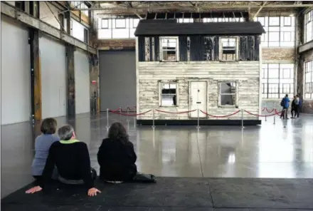  ?? STEVEN SENNE — ASSOCIATED PRESS FILE PHOTO ?? In this April 1, 2018 file photo, visitors view the rebuilt house of Rosa Parks at the WaterFire Arts Center in Providence, R.I. The house where Parks sought refuge in Detroit after fleeing the South will be auctioned on Thursday, July 26 in New York, with a minimum bid of $1 million.