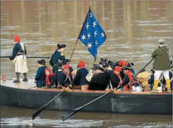  ?? TRENTONIAN FILE PHOTO ?? General George Washington (standing left) portrayed by John Godzieba and his soldiers man a Durham Boat during the 61st Annual Re-enactment of Washington Crossing the Delaware River.