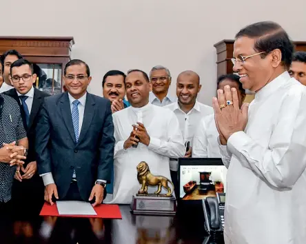  ??  ?? CHANGING DYNAMICS Mahinda Rajapaksa (left) at his swearing-in as Sri Lanka’s new prime minister before President Maithripal­a Sirisena (right) on October 26